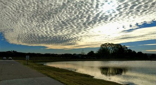 Scenic view of lake against sky at sunset