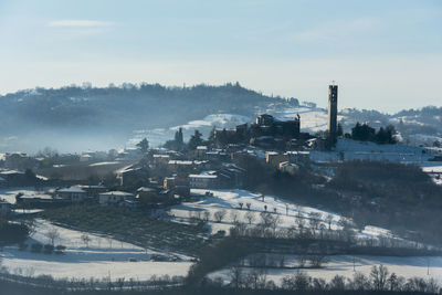 Fog in the snow in the hills of sovizzo with small snow-covered villages in vicenza, italy