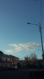 Cars on road against blue sky