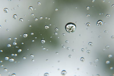 Full frame shot of raindrops on water