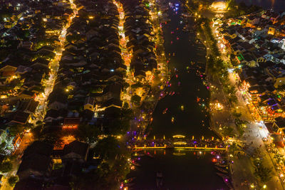 Illuminated christmas tree in city at night