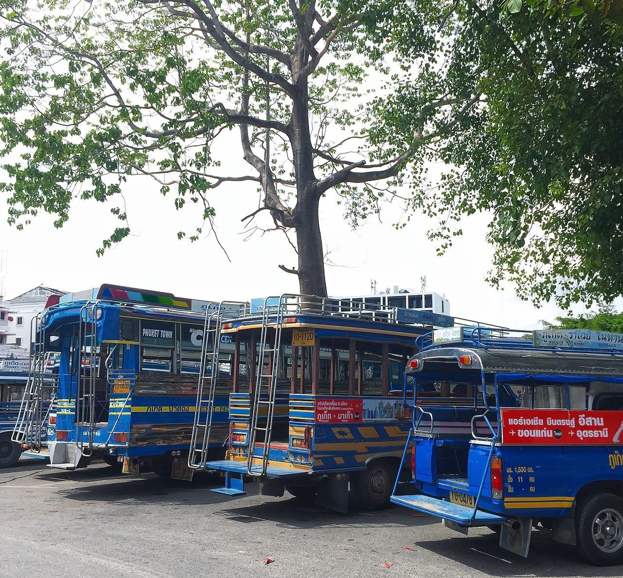 CARS ON STREET IN CITY AGAINST SKY IN BACKGROUND