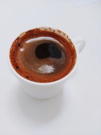 High angle view of coffee cup over white background