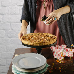 Midsection of woman preparing sweet pie