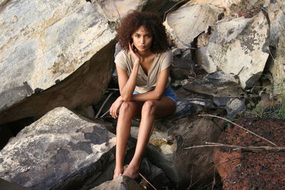 Young woman sitting on rock