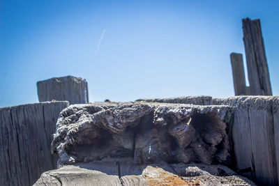 View of rocks against clear blue sky
