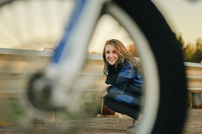 Portrait of smiling young woman against sky