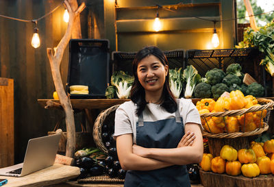 Portrait of woman holding fruits at restaurant