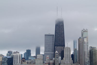 Modern buildings in city against sky