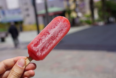 Close-up of hand holding ice cream cone