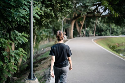 Rear view point of young woman walking on the way , hope and dream concept