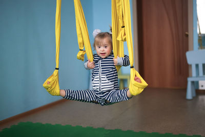 Rear view of boy swinging at playground