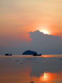 Scenic view of sea against orange sky