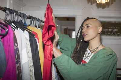 A young woman holding a shirt