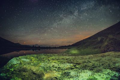 Scenic view of mountains against sky at night