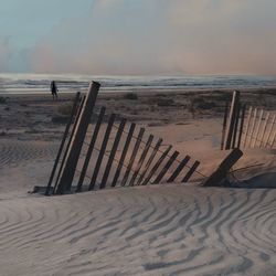 Scenic view of beach against sky during sunset