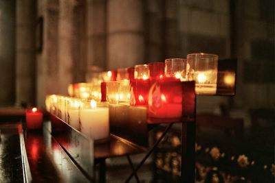 Close-up of illuminated tea light candles on table