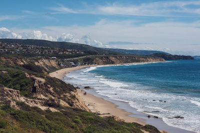 Scenic view of sea and mountains against sky