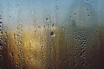 Close-up of raindrops on glass window