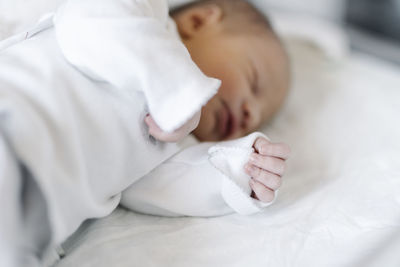 Newborn baby sleeping on bed