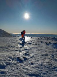 Family on winter holidays looking at sunny tatra mountains