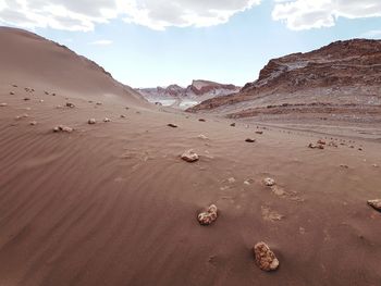 Scenic view of red desert against sky