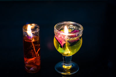 Close-up of wineglass on table against black background
