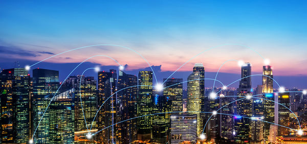 Digital composite image of illuminated buildings in city against sky