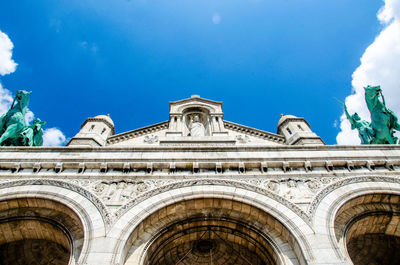 Low angle view of historic building against blue sky