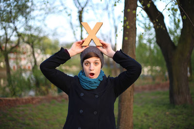 Happy girl holding letter x