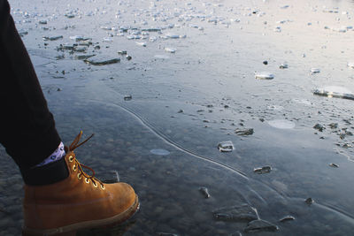 Low section of woman standing on water