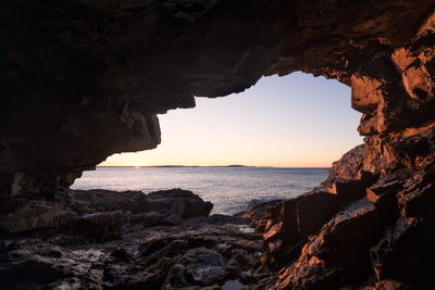 Scenic view of sea seen through cave