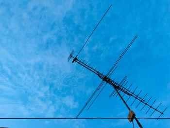 Low angle view of cables against blue sky