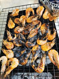 High angle view of meat on barbecue grill