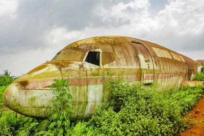 Abandoned built structure on field against sky