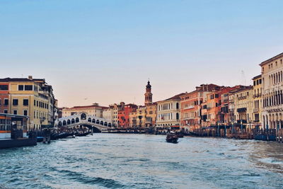 Buildings by grand canal against clear sky