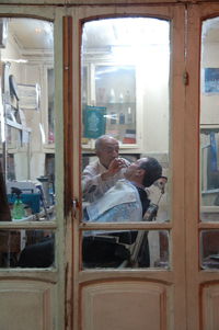 People sitting in glass window