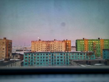 Buildings in city against sky