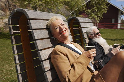 Mature woman relaxing on bench