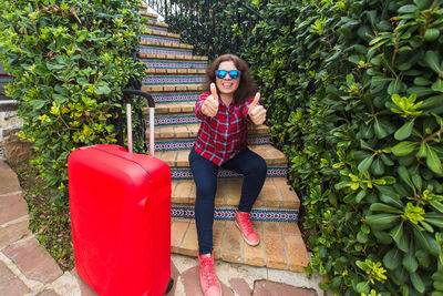 Portrait of smiling young woman sitting on chair