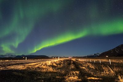 Scenic view of field against sky at night