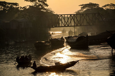 Silhouette boats in water against sky