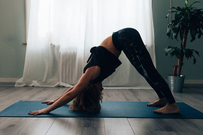 Yogic woman practicing in yoga studio