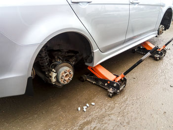 High angle view of jack under car on street