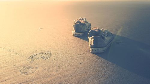 Close-up of sand on beach against sky during sunset