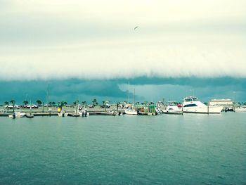 Sailboats in sea against sky