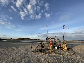 People on beach against sky