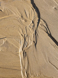 Low tide outflow marks on a sandy beach