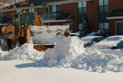 Snow covered land by building