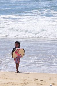 Full length of woman standing on beach